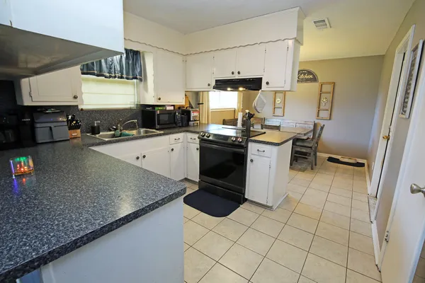 a kitchen with a sink a stove and refrigerator