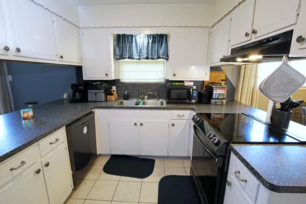 a kitchen with stainless steel appliances a sink stove and cabinets
