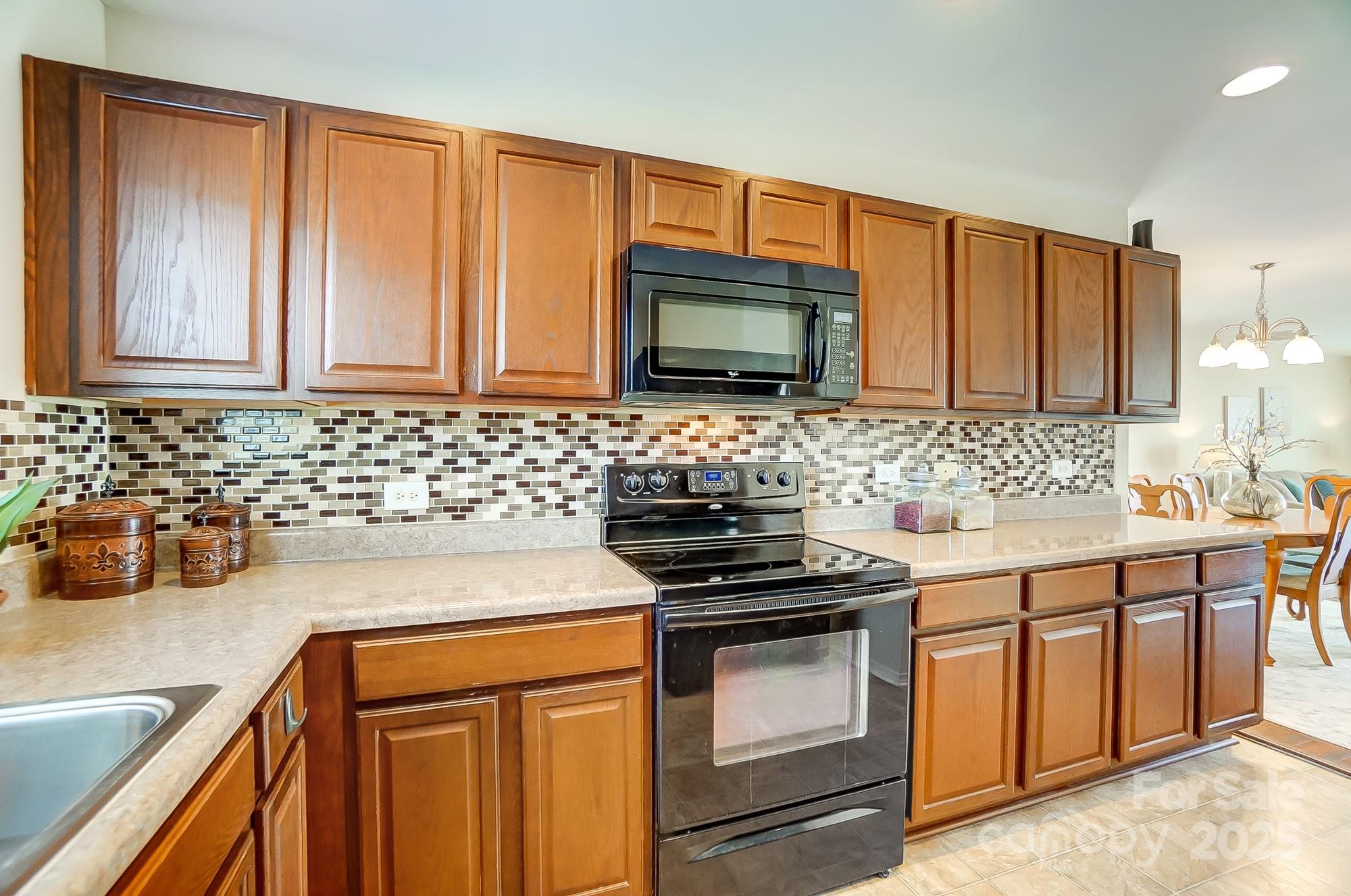 309 River Clay Road Fort Mill, SC 29708 - Photo 13 of 35 a kitchen with granite countertop a sink stove and microwave