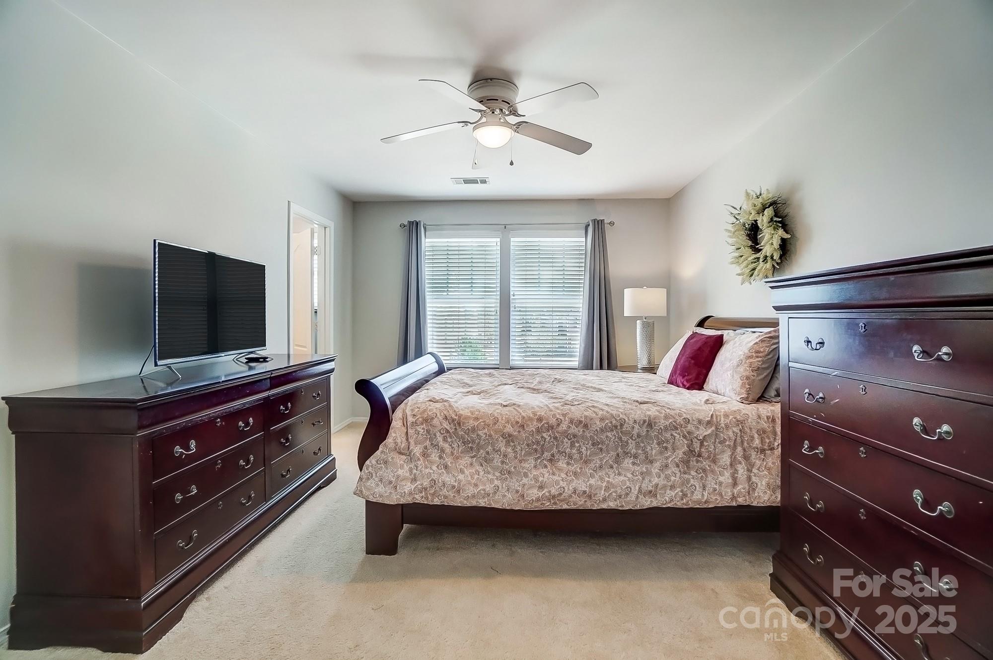 309 River Clay Road Fort Mill, SC 29708 - Photo 20 of 35 a bedroom with a bed and a flat screen tv