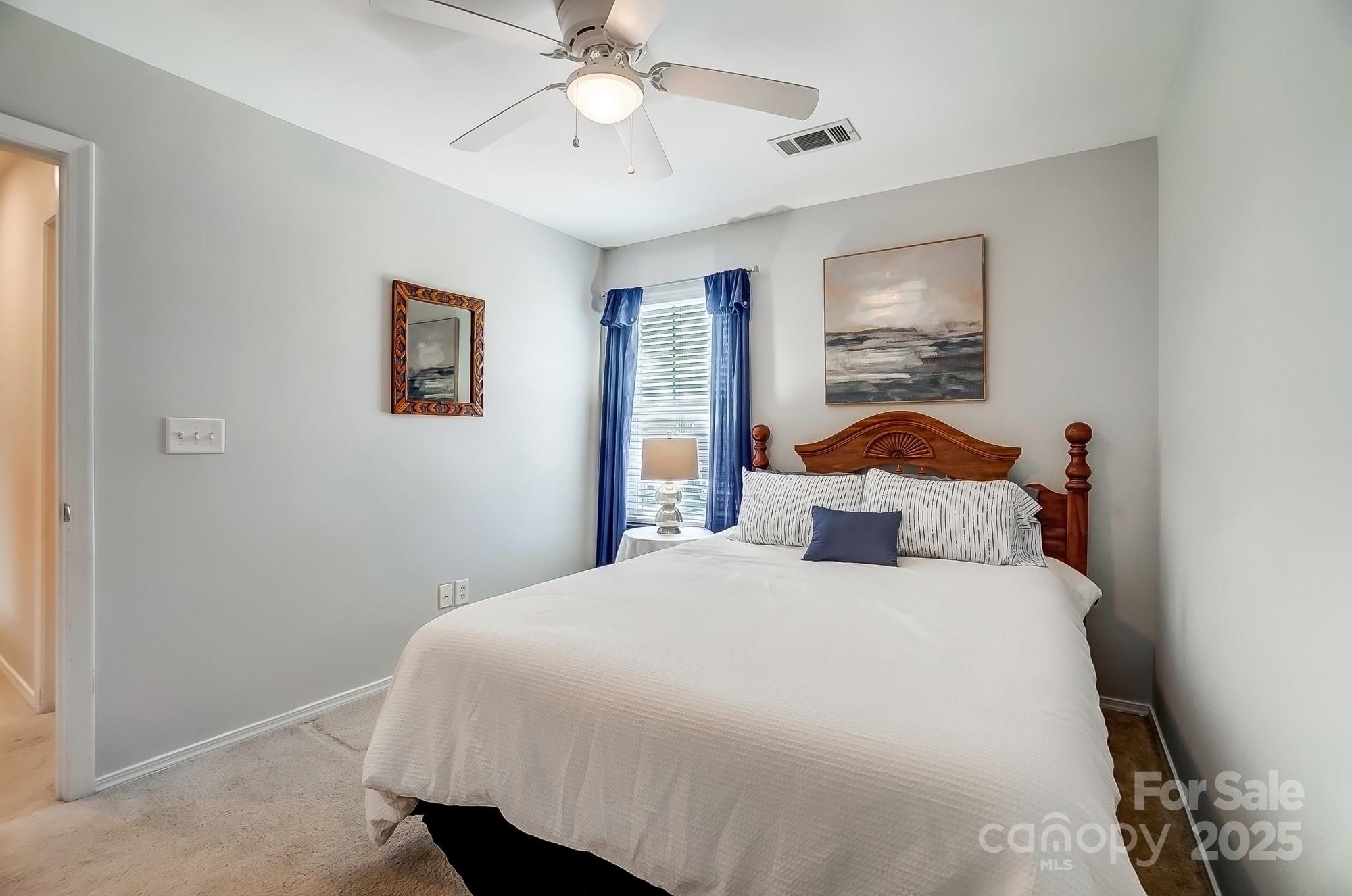 309 River Clay Road Fort Mill, SC 29708 - Photo 26 of 35 a bedroom with a bed and a chandelier