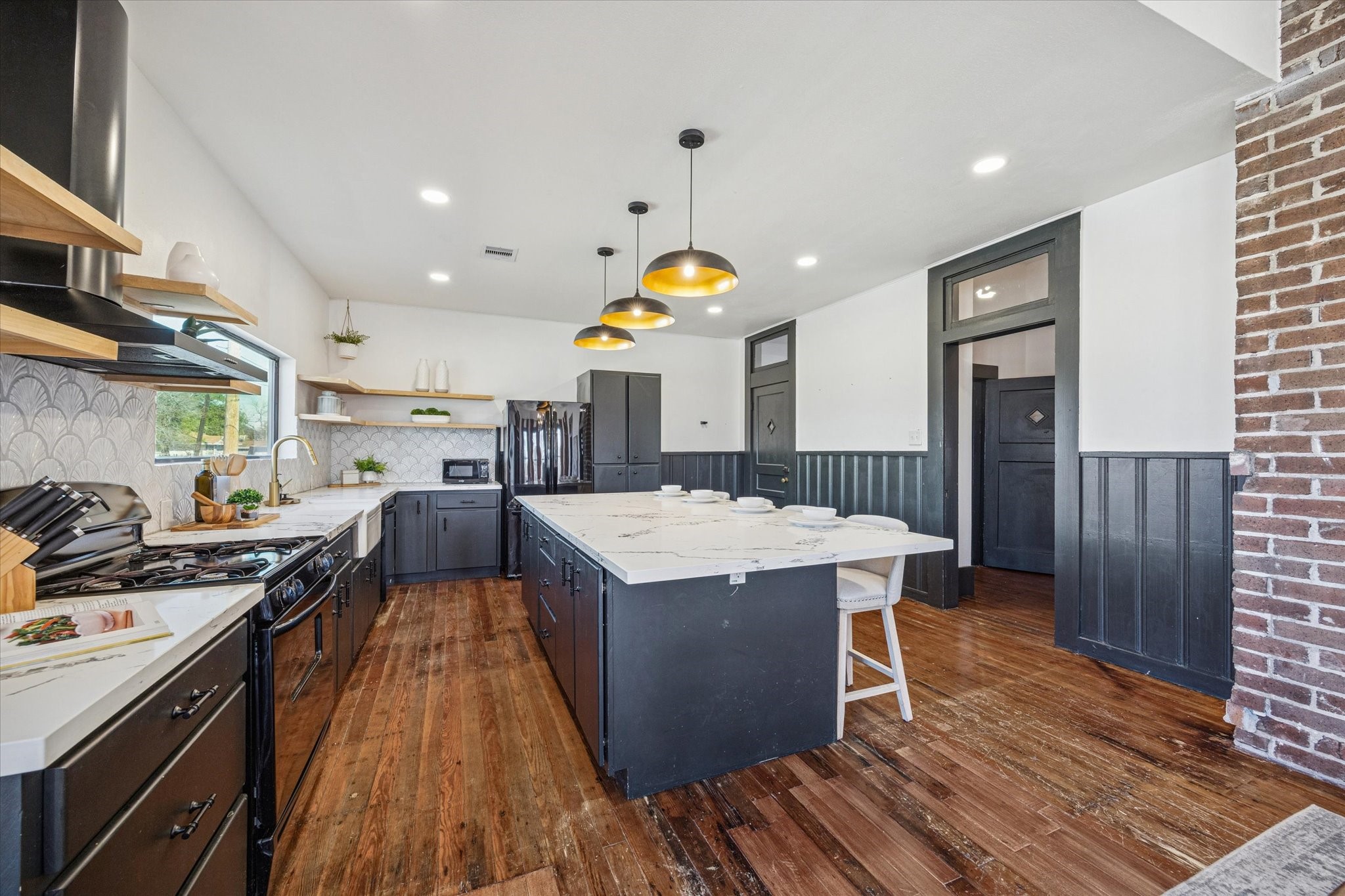 1920 Fulton Street Houston, TX 77009 - Photo 13 of 39 a kitchen with stainless steel appliances granite countertop a stove and a refrigerator