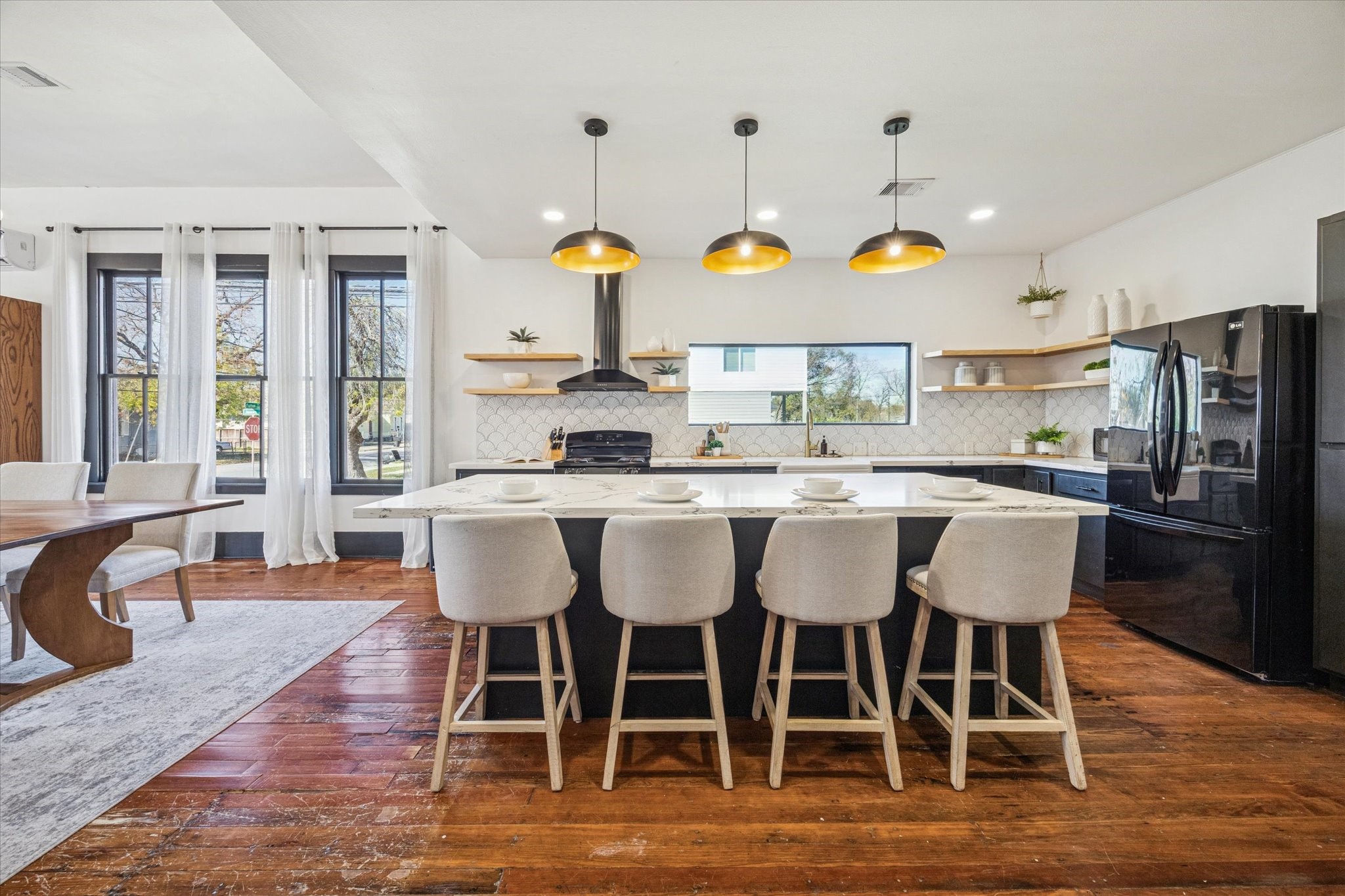 1920 Fulton Street Houston, TX 77009 - Photo 19 of 39 a kitchen with stainless steel appliances granite countertop a dining table chairs and wooden floor