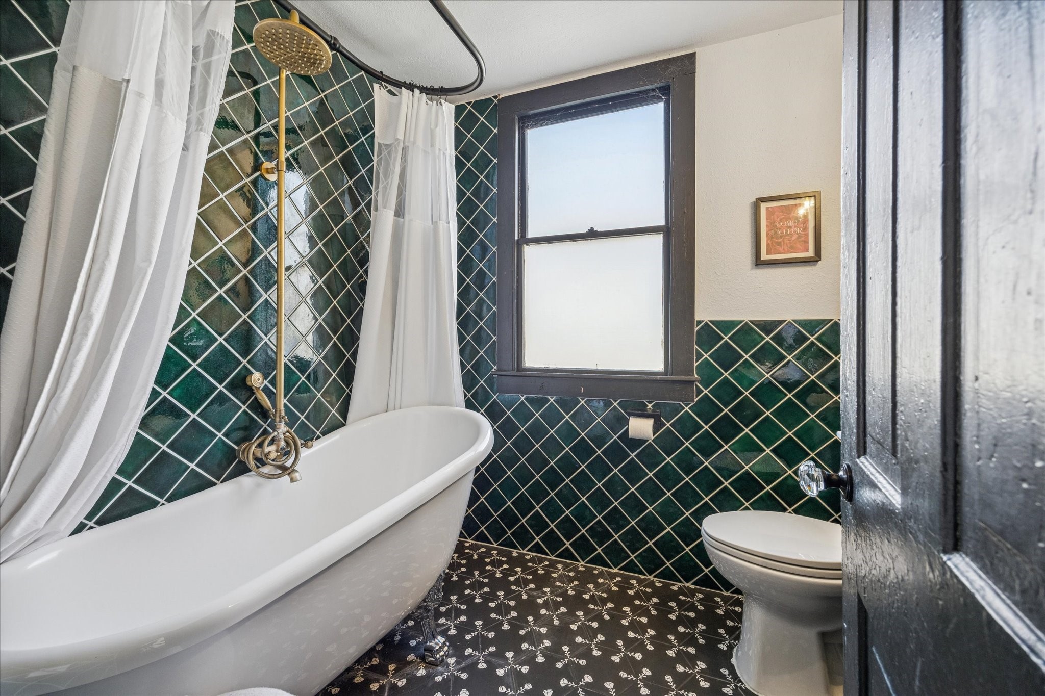 1920 Fulton Street Houston, TX 77009 - Photo 23 of 39 a bathroom with a toilet and a shower curtain