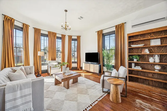 a living room with furniture and a chandelier