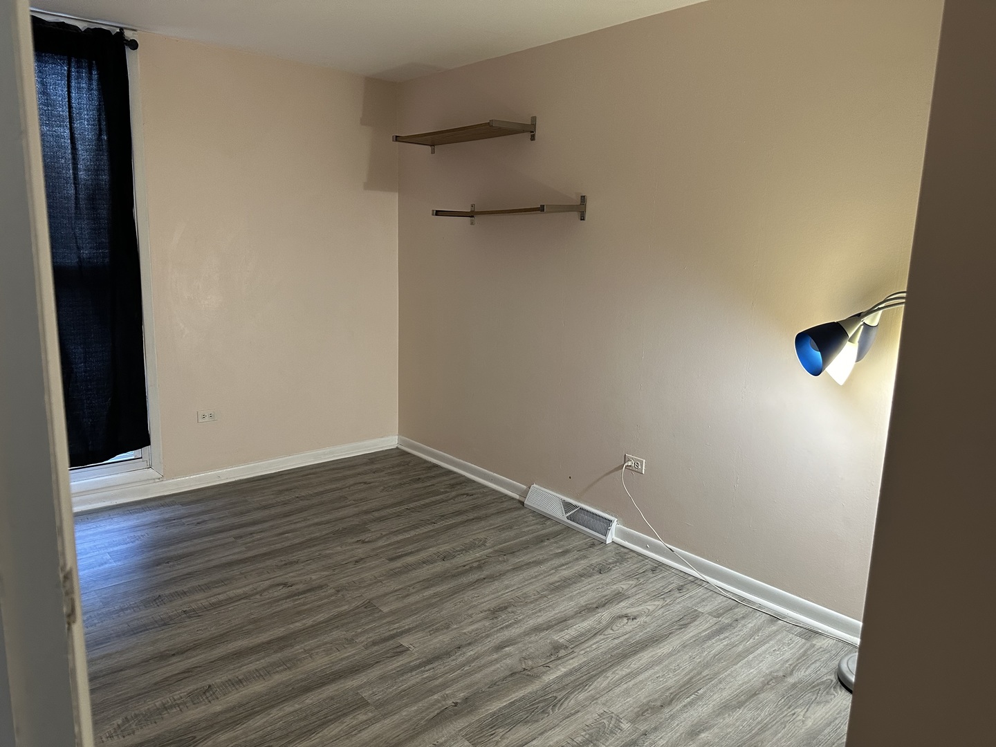 1876 Mannheim Road Des Plaines, IL 60018 - Photo 11 of 19 a view of an empty room with wooden floor and a window