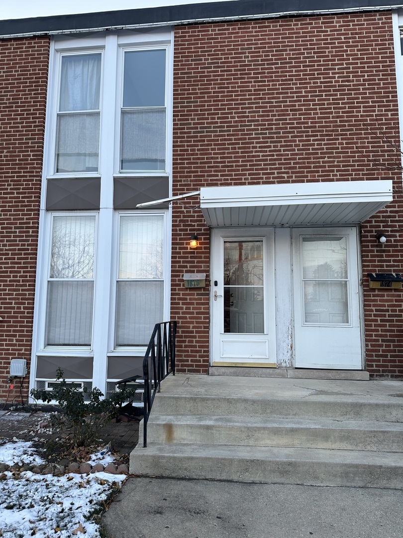 1876 Mannheim Road Des Plaines, IL 60018 - Photo 2 of 19 a front view of a house with a garden
