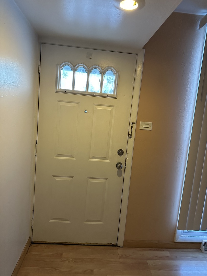 1876 Mannheim Road Des Plaines, IL 60018 - Photo 3 of 19 an empty room with wooden floor and windows