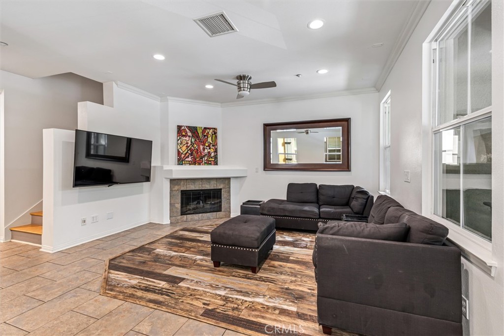 119 Jadestone Irvine, CA 92603 - Photo 2 of 27 a living room with furniture a flat screen tv and a fireplace