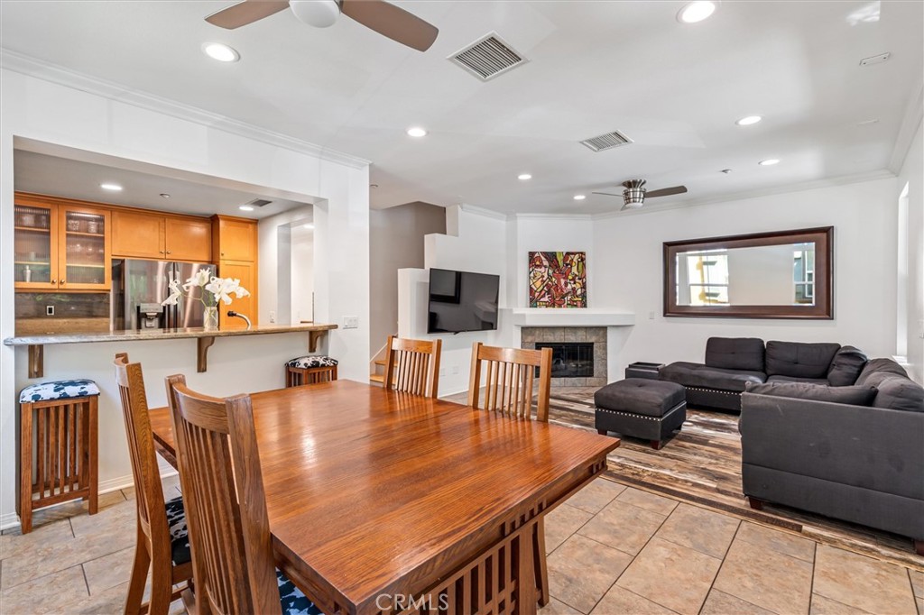 119 Jadestone Irvine, CA 92603 - Photo 6 of 27 a living room with furniture a flat screen tv and a large window