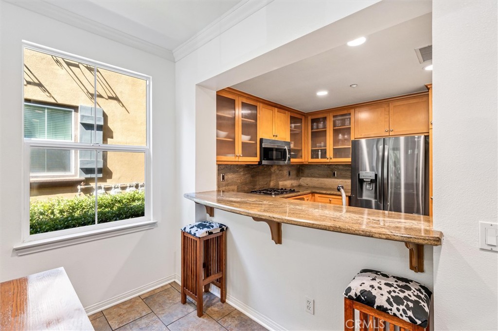 119 Jadestone Irvine, CA 92603 - Photo 7 of 27 a kitchen with stainless steel appliances granite countertop sink microwave and window