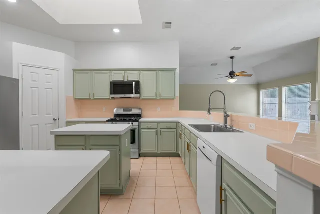 a kitchen with a sink stove and cabinets