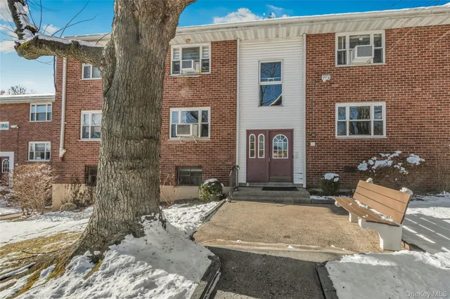 a view of a brick house with many windows