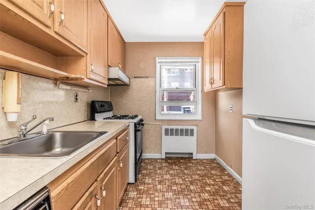 a kitchen with a sink stove and refrigerator