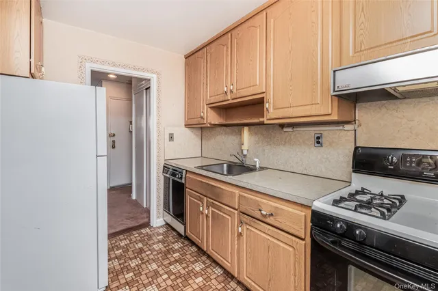a kitchen with stainless steel appliances granite countertop a stove a refrigerator and a microwave