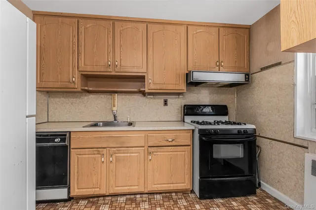 a kitchen with stainless steel appliances granite countertop a stove a refrigerator and cabinets