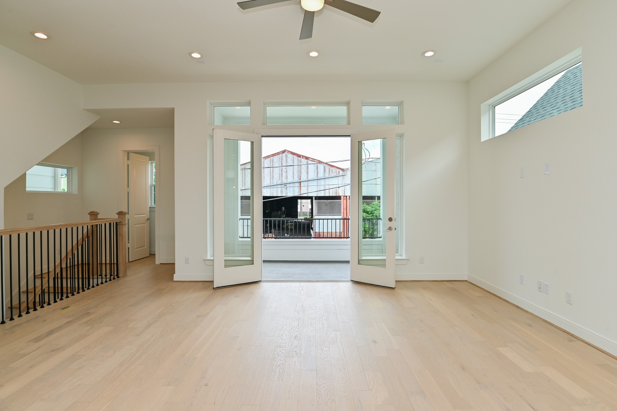 4619 Maxie Street Houston, TX 77007 - Photo 15 of 45 an empty room with floor to ceiling window and chandelier fan