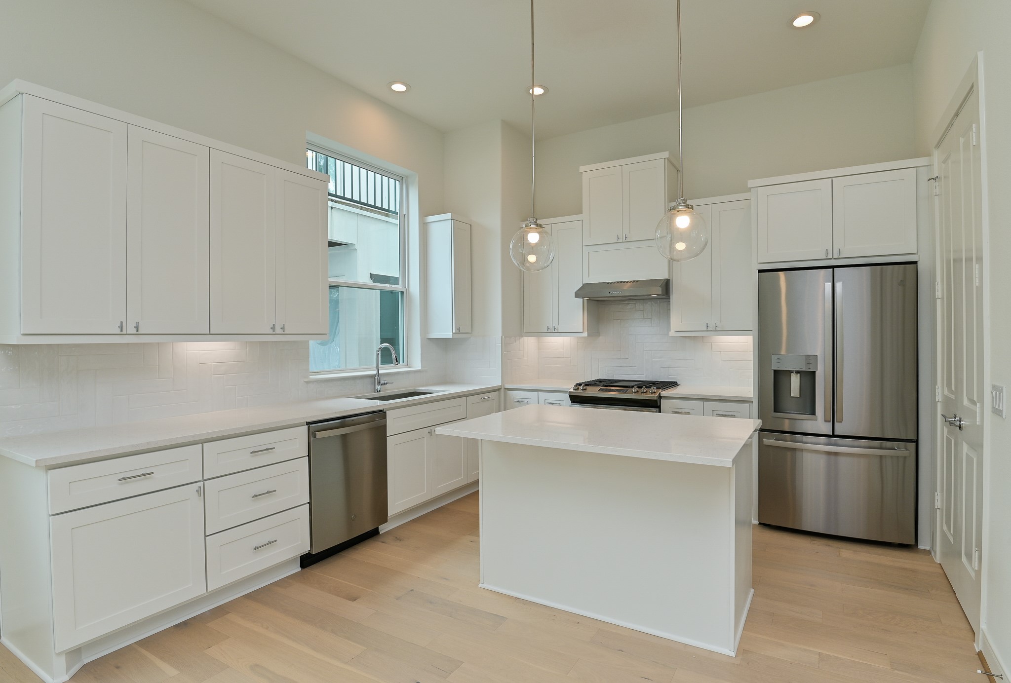 4619 Maxie Street Houston, TX 77007 - Photo 21 of 45 a kitchen with stainless steel appliances granite countertop a refrigerator a sink a stove and white cabinets