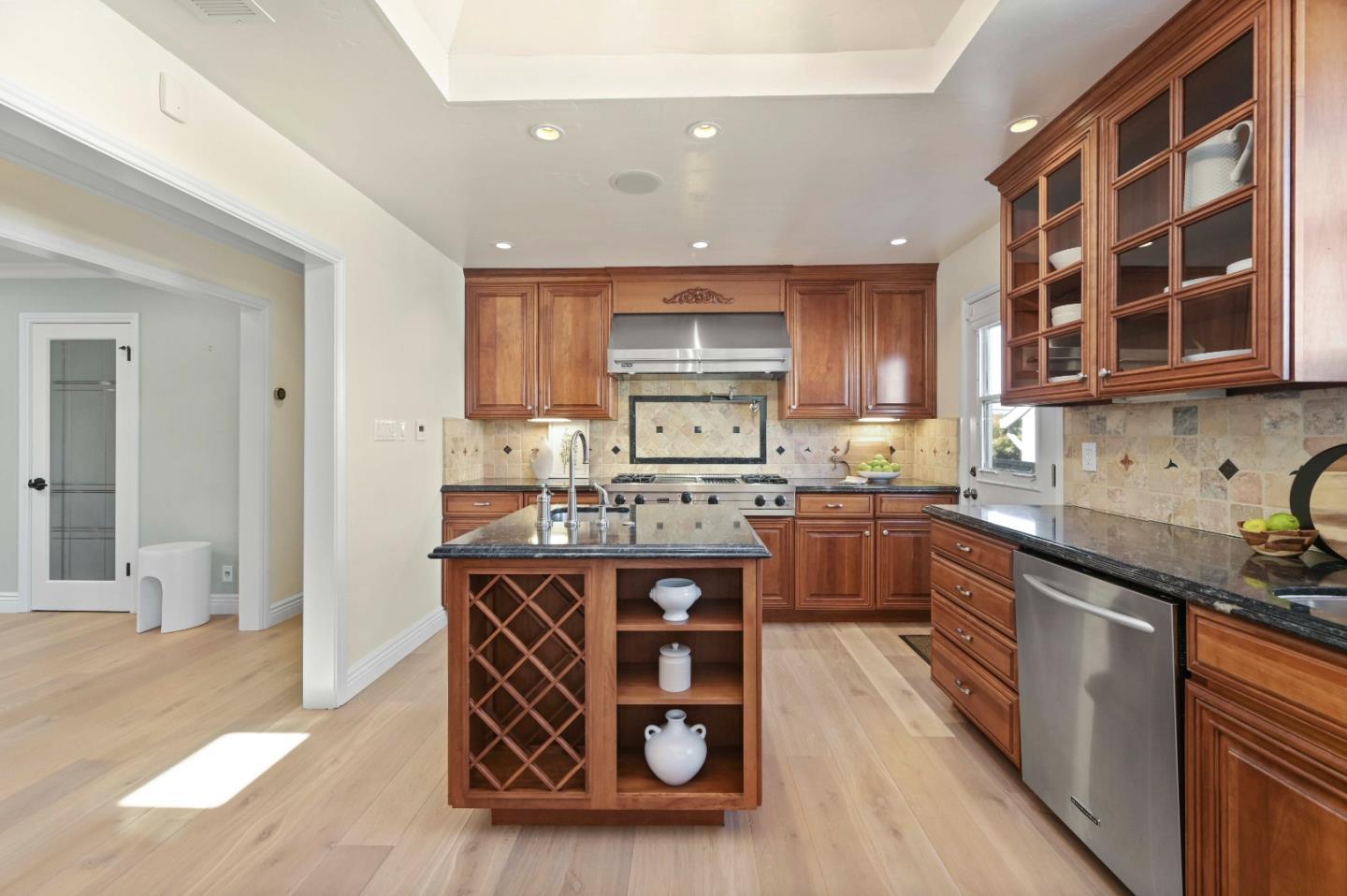 754 26th Avenue San Mateo, CA 94403 - Photo 51 of 57 a kitchen with stainless steel appliances granite countertop a stove a sink dishwasher and cabinets with wooden floor