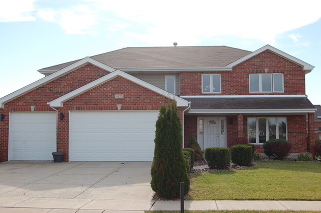 4975 Cardinal Court Monee, IL 60449 - Photo 1 of 9 a front view of a house with a yard