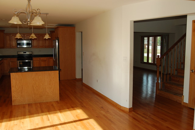 4975 Cardinal Court Monee, IL 60449 - Photo 4 of 9 a view of hallway with wooden floor