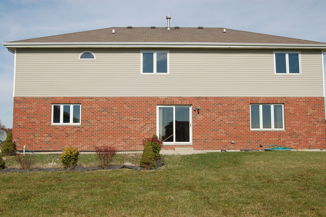 4975 Cardinal Court Monee, IL 60449 - Photo 9 of 9 a front view of a house with garden