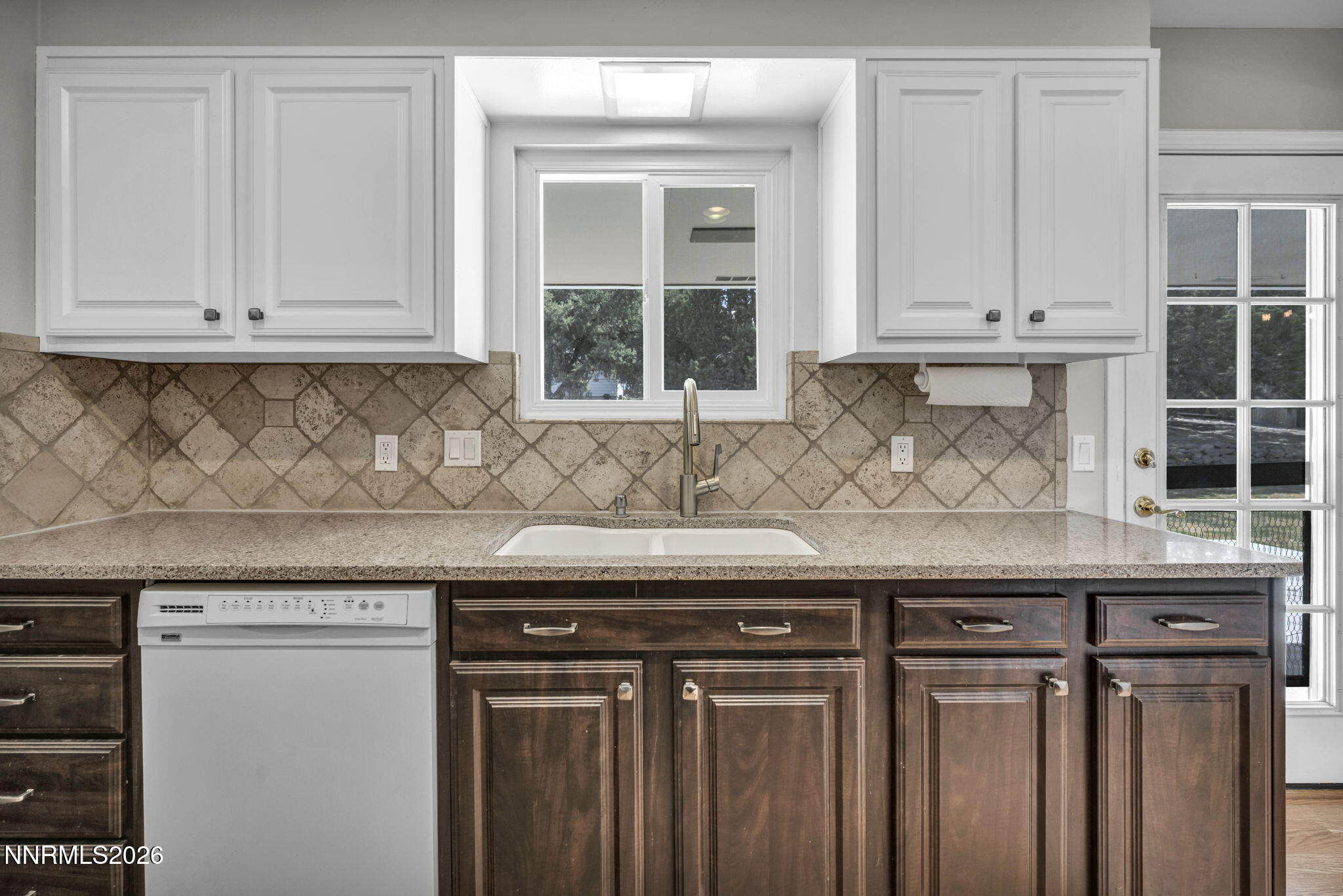 14190 Rim Rock Drive Reno, NV 89521 - Photo 23 of 68 a kitchen with granite countertop white cabinets and sink