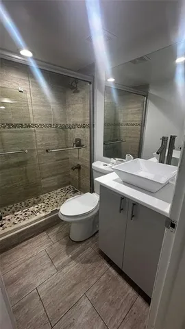 a bathroom with a sink toilet and shower