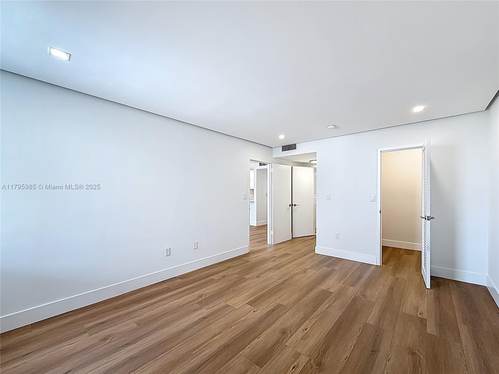 2899 Collins Avenue, Unit 1218 Miami Beach, FL 33140 - Photo 23 of 41 a view of an empty room with wooden floor