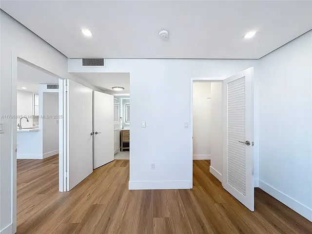 a view of hallway with wooden floor