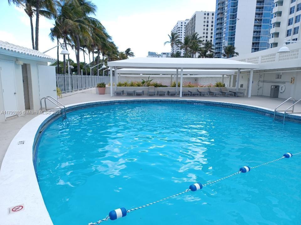 2899 Collins Avenue, Unit 1218 Miami Beach, FL 33140 - Photo 40 of 41 a view of a swimming pool with outdoor seating
