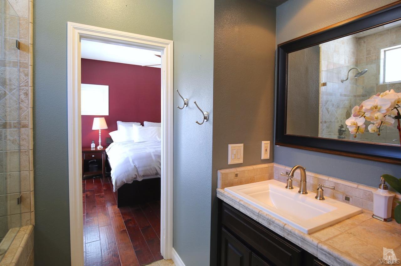 4241 Rusticview Court Moorpark, CA 93021 - Photo 15 of 26 a en suite bathroom with a sink and mirror