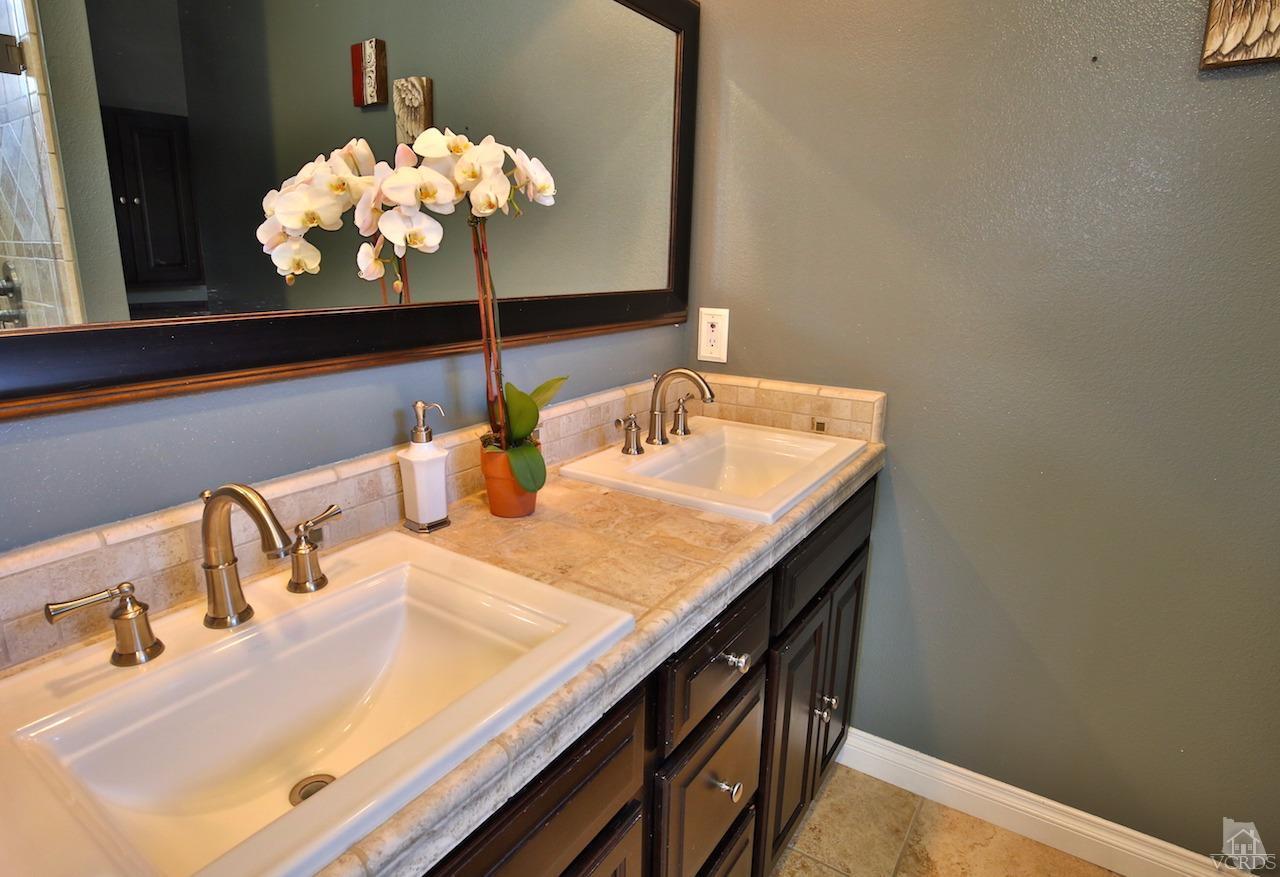 4241 Rusticview Court Moorpark, CA 93021 - Photo 16 of 26 a bathroom with a sink and a mirror