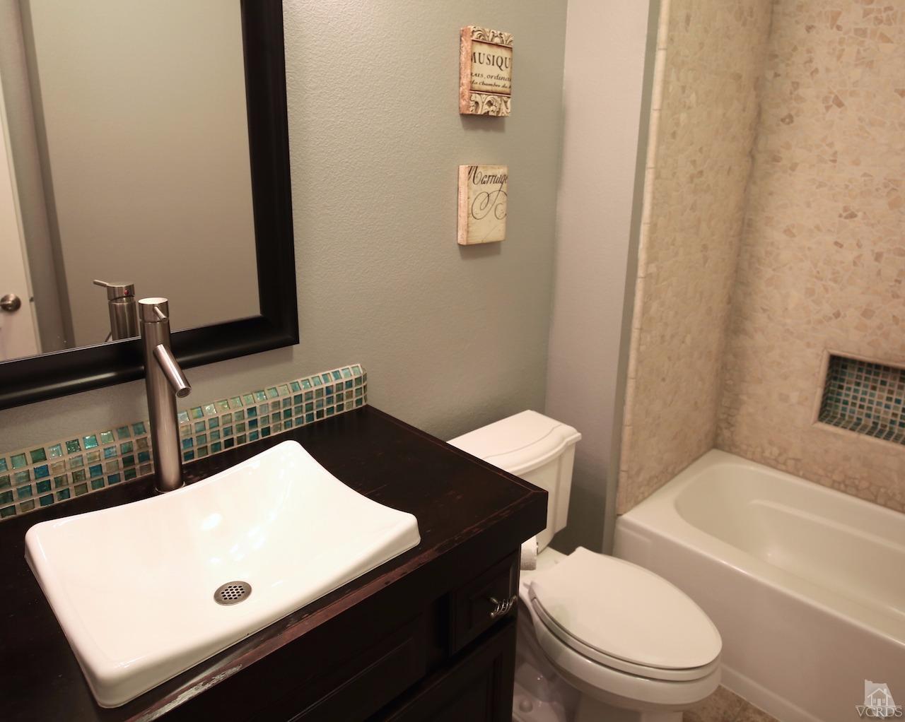 4241 Rusticview Court Moorpark, CA 93021 - Photo 21 of 26 a bathroom with a toilet sink and mirror