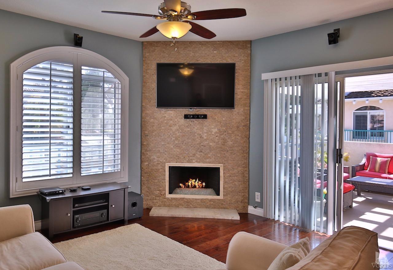 4241 Rusticview Court Moorpark, CA 93021 - Photo 7 of 26 a living room with furniture a fireplace and a flat screen tv