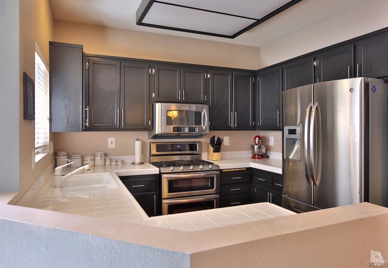 4241 Rusticview Court Moorpark, CA 93021 - Photo 10 of 26 a kitchen with stainless steel appliances a refrigerator stove microwave and sink