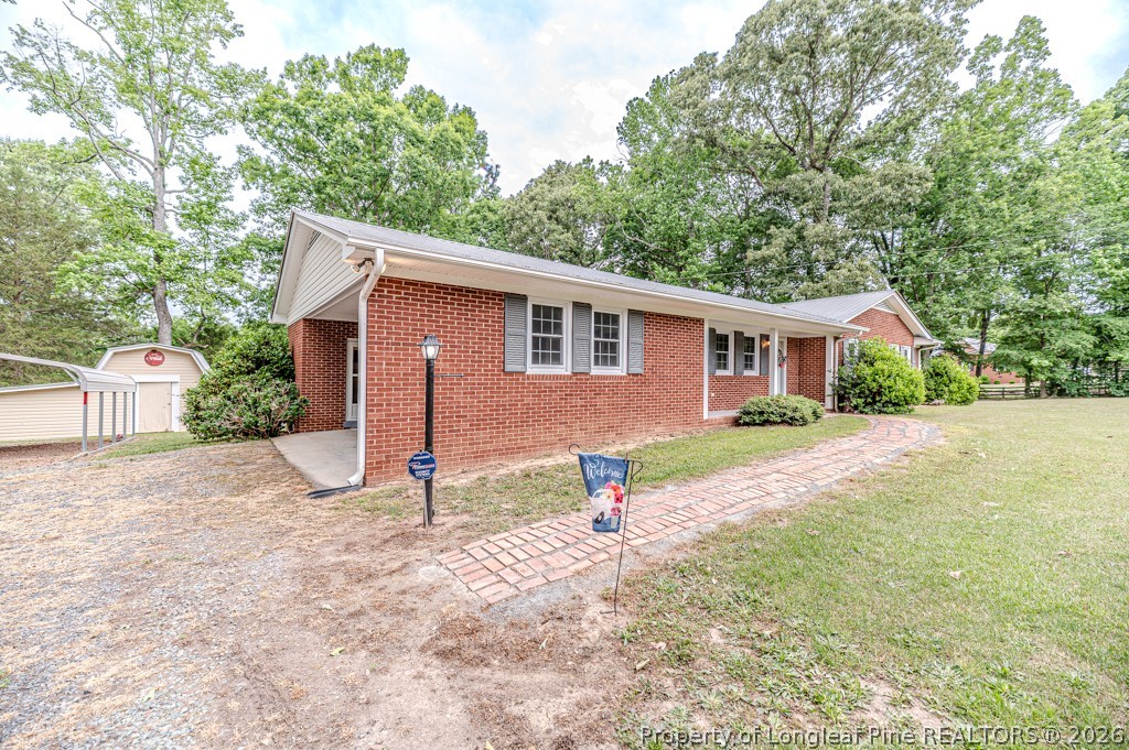 3384 Goldston Glendon Road Goldston, NC 27252 - Photo 36 of 47 a front view of house with yard and trees in the background