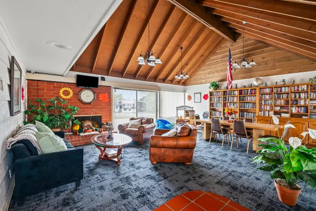 a view of a patio with table and chairs under an umbrella