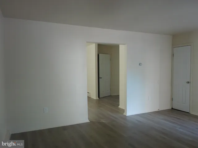 a view of room with hardwood floor and ceiling fan
