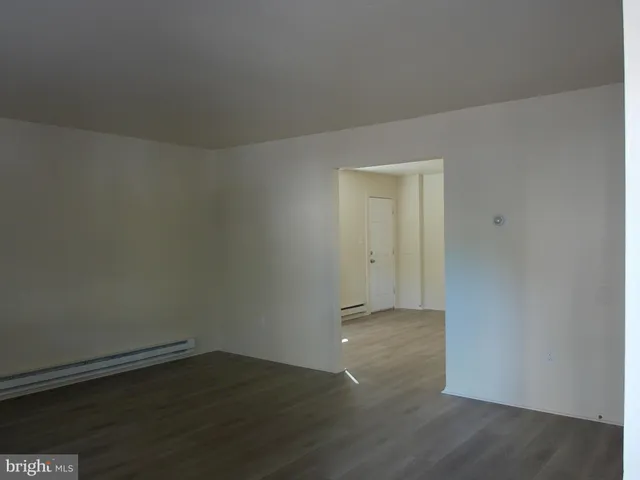 an empty room with wooden floor