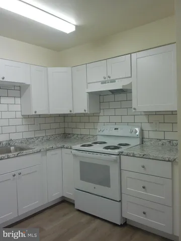a kitchen with sink cabinets and a refrigerator