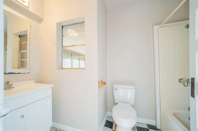a white toilet sitting next to a bathroom sink