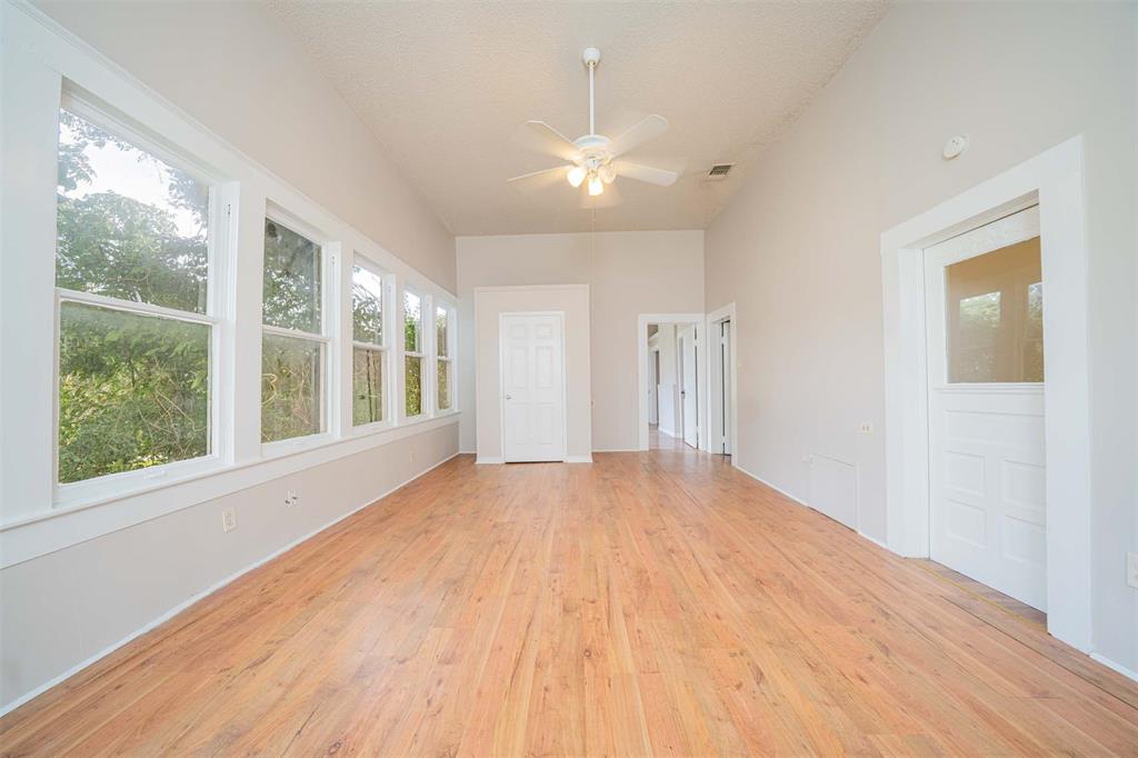 100 West Groves Street Big Sandy, TX 75755 - Photo 16 of 30 a view of an empty room with wooden floor and a window