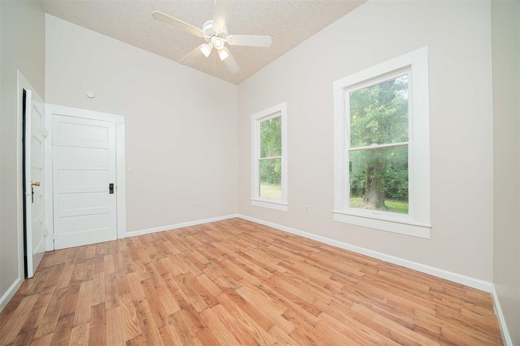 100 West Groves Street Big Sandy, TX 75755 - Photo 18 of 30 a view of empty room with wooden floor and fan