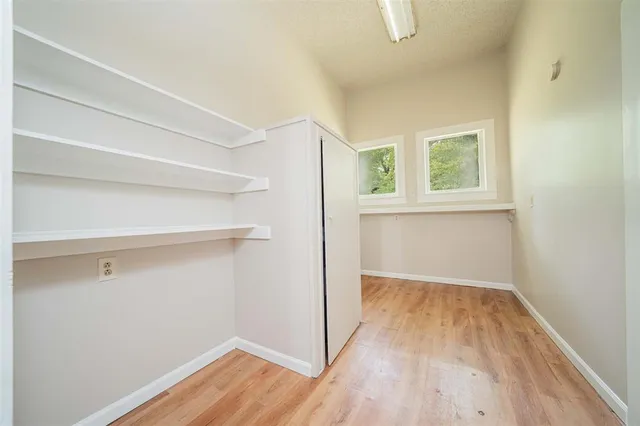 a view of a room with wooden floor and cabinet