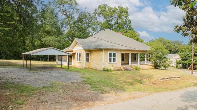 a house with swimming pool in front of it