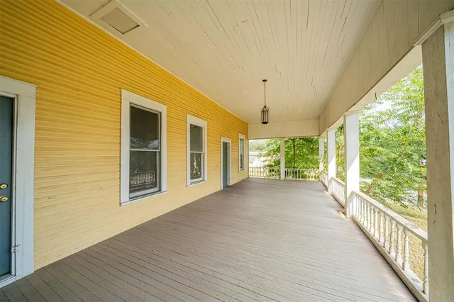 a view of a porch with wooden floor and outdoor space