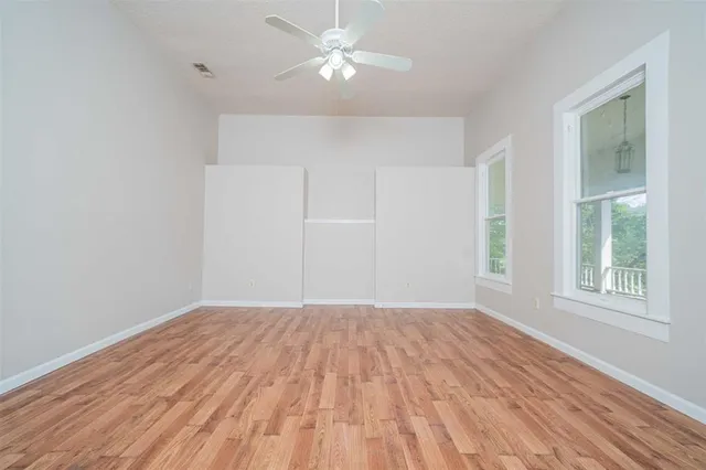 wooden floor in an empty room with a window