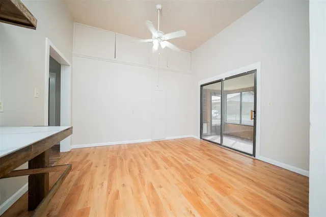 a view of an empty room with cabinet and a window