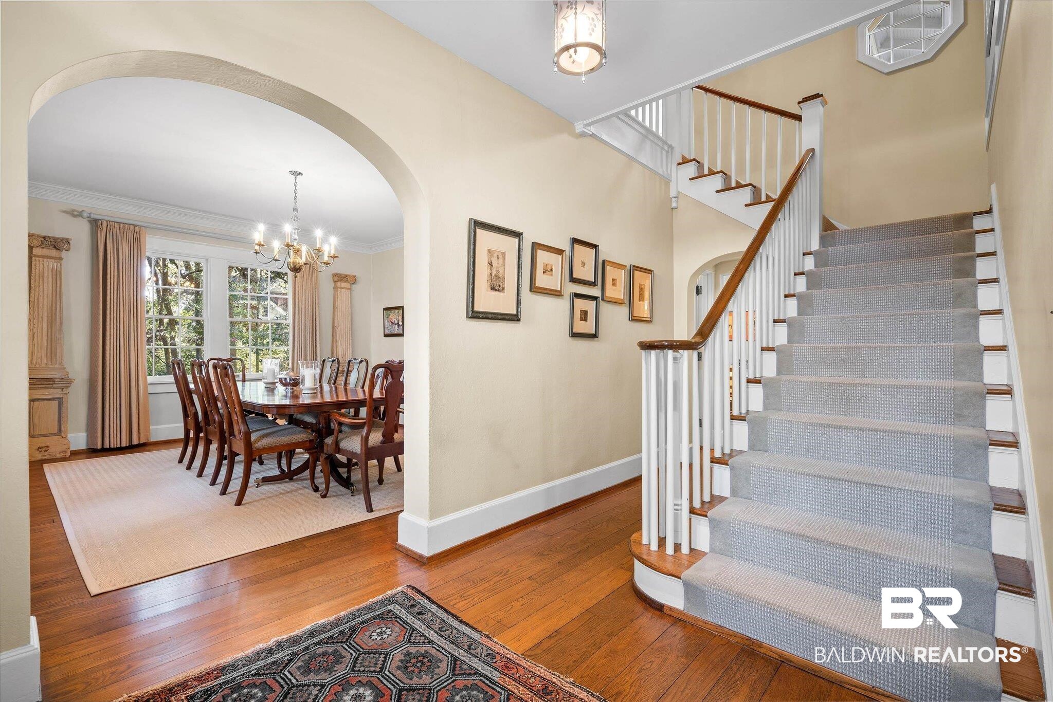 2 Westgate Road Mobile, AL 36608 - Photo 5 of 63 Foyer entrance featuring arched walkways, light wood-type flooring, hanging lights, and ornamental molding